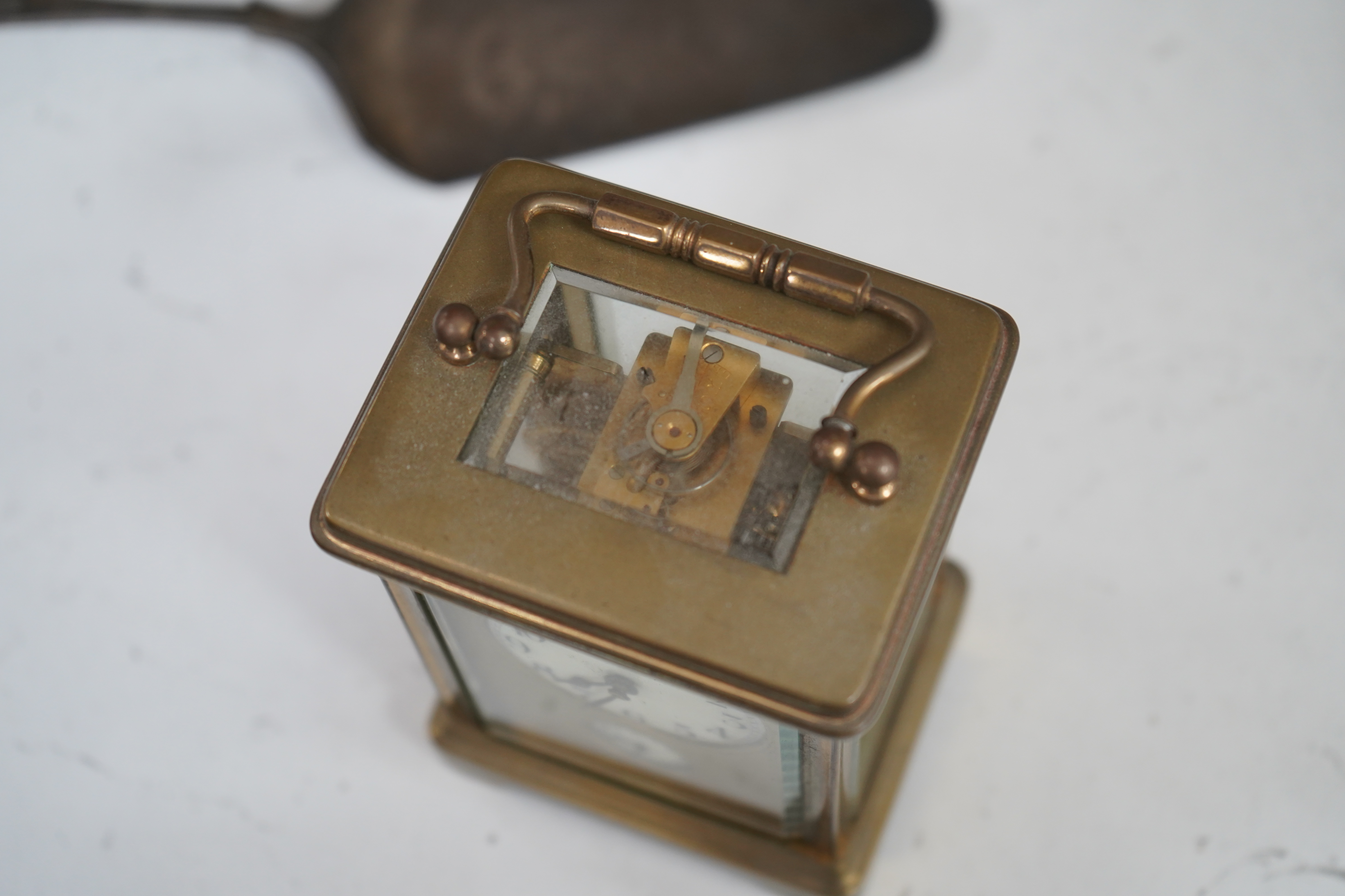 A small collection of metalware to include a white metal mounted tortoiseshell box, brass cased carriage clock with subsidiary dial and a pewter tankard. Condition - poor to fair